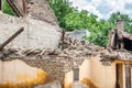 Aftermath damaged and collapsed roof on ruined house with wooden construction frame and brick wall Royalty Free Stock Photo