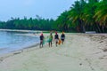 An afternoon on an african island. Four fisher women walking on a white sand beach Royalty Free Stock Photo