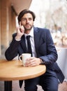 Afternoon reflection over a warm cup of coffee. A thoughtful young businessman sitting with a cup of coffee outside at a