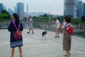 Shenzhen, China: women walk their dogs outdoors and play with their pets.