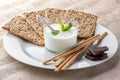 Afternoon snack with health crackers, bread sticks and kefir