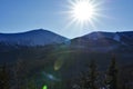 Afternoon sun over winter mountains and forest Royalty Free Stock Photo