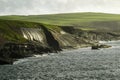 Afternoon sun shimmers on wet mossy Kilkee Cliffs along Wild Atlantic Way, County Clare, Ireland. Royalty Free Stock Photo