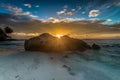 Afternoon sunlight from behind a large rock Royalty Free Stock Photo