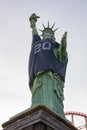 Afternoon sunny view of the Statue of Liberty wear Raiders football shirt and face mask