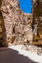 Afternoon sunshine illuminates the narrow gorge leading to the ancient city of Petra, Jordan