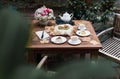 Afternoon tea basque burnt cheesecake and tea cup with teapot on wooden table. Royalty Free Stock Photo