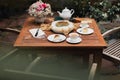 Afternoon tea basque burnt cheesecake and tea cup with teapot on wooden table. Royalty Free Stock Photo