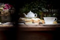 Afternoon tea basque burnt cheesecake and tea cup with teapot on wooden table. Royalty Free Stock Photo