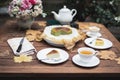 Afternoon tea basque burnt cheesecake and tea cup with teapot on wooden table. Royalty Free Stock Photo