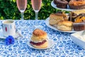 Afternoon tea with cakes and traditional English scones Royalty Free Stock Photo