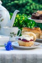 Afternoon tea with cakes and traditional English scones Royalty Free Stock Photo