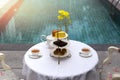 Afternoon tea with cup of tea and teapot on table with cake