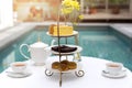 Afternoon tea with cup of tea and teapot on table with cake