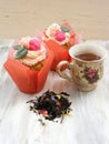 Afternoon tea with flowers cupcakes in vintage teacup and petals brew on shabby table colors of spring Royalty Free Stock Photo