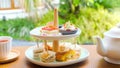 Afternoon tea with fresh cakes, pastries and sandwiches with hot tea