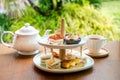 Afternoon tea with fresh cakes, pastries and sandwiches with hot tea Royalty Free Stock Photo