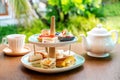 Afternoon tea with fresh cakes, pastries and sandwiches with hot tea Royalty Free Stock Photo