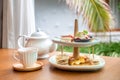 Afternoon tea with fresh cakes, pastries and sandwiches with hot tea Royalty Free Stock Photo