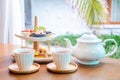 Afternoon tea with fresh cakes, pastries and sandwiches with hot tea