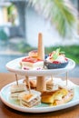 Afternoon tea with fresh cakes, pastries and sandwiches with hot tea