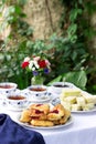 Afternoon tea in the garden with scones, strawberry jam, finger sandwiches with cucumber and egg salad. Royalty Free Stock Photo