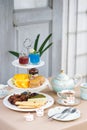 Afternoon tea. Tea party with unicorn macarons, scones, bakeries