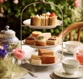 Afternoon tea in the restaurant garden, English tradition and luxury service, tea cups, cakes, scones, sanwiches and desserts, Royalty Free Stock Photo