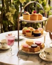 Afternoon tea in the restaurant garden, English tradition and luxury service, tea cups, cakes, scones, sanwiches and desserts, Royalty Free Stock Photo