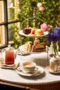 Afternoon tea in the restaurant garden, English tradition and luxury service, tea cups, cakes, scones, sanwiches and desserts, Royalty Free Stock Photo