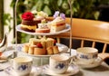 Afternoon tea in the restaurant garden, English tradition and luxury service, tea cups, cakes, scones, sanwiches and desserts, Royalty Free Stock Photo