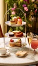 Afternoon tea in the restaurant garden, English tradition and luxury service, tea cups, cakes, scones, sanwiches and desserts, Royalty Free Stock Photo