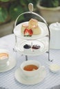 Afternoon Tea. A set of scones and clotted cream served with hot tea for English Afternoon Tea party outdoor. Selective focus on