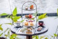 Afternoon tea stand in outdoor luxury restaurant with pond backdrop