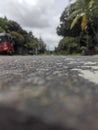 An afternoon view of a tarmac road with traffic in Sri Lanka.