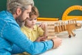 Afterschool tutoring. Kid and teacher is learning in class on background of blackboard. Preschool tutorship. Preschool