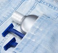 Aftershave lotion and disposable razors in blue jeans pocket Royalty Free Stock Photo