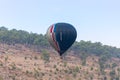 Black - grey hot air balloon flies up from the ground at the hot air balloon festival