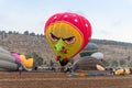 The maintenance team inflate the hot air balloons on the ground before the flight at the hot air balloon festival