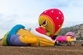 The maintenance team inflates the hot air balloon on the ground before the flight at the hot air balloon festival