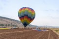 Pilots of a striped air hot balloon are preparing to fly out at the festival of ais hot balloons