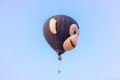 In the sky hot air balloon in the shape of head of a monkey withIn the sky hot air balloon in the shape of head of a monkey with t