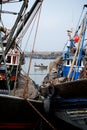 African fishing boats docked in a harbor next to the wholesale market