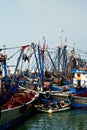 African fishing boats docked in a harbor next to the wholesale market