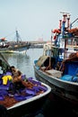 african fishing boats docked in a harbor next to the wholesale market