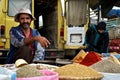 local man selling spices and grains at the market