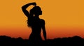 Silhouette of strong and empowered woman on orange sunset sky