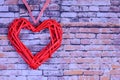 Against the background of a brick wall on the left side there is a decorative red heart. On the right there is a place Royalty Free Stock Photo