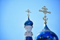 Against the background of a clear blue sky, two domes of a Christian church of different sizes, with crosses at the top Royalty Free Stock Photo