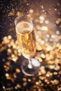 Against the background of confetti and lights, a glass of sparkling wine. Holiday concept